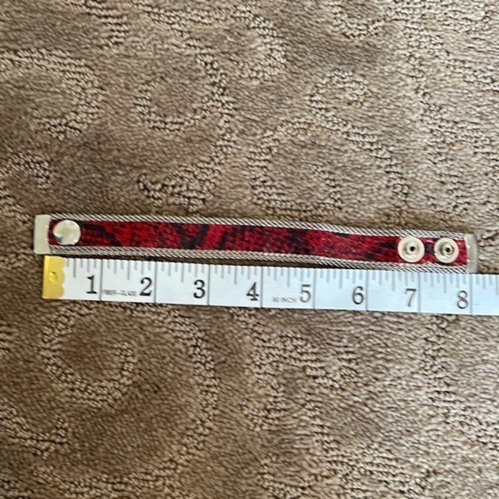 Red snakeskin and silver tone bracelet.